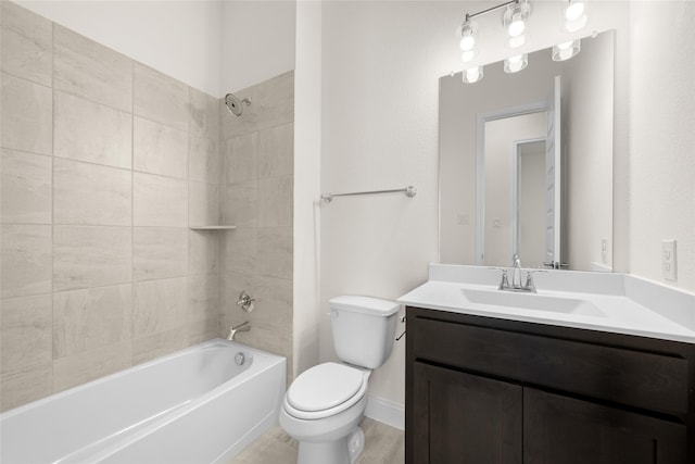 full bathroom with toilet, tiled shower / bath, and vanity