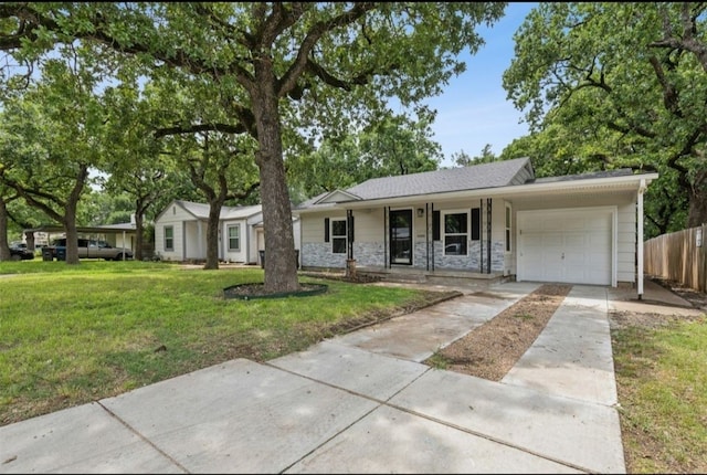 ranch-style home featuring a garage and a front yard