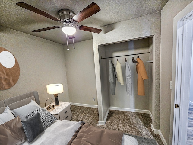 carpeted bedroom with ceiling fan and a closet