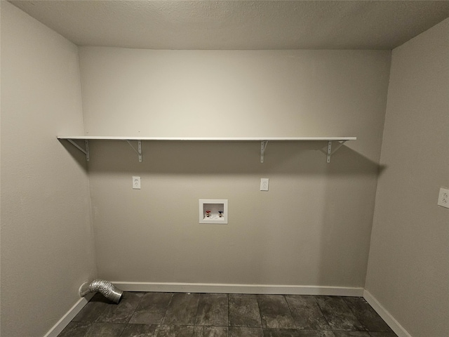 washroom featuring dark tile patterned floors and washer hookup