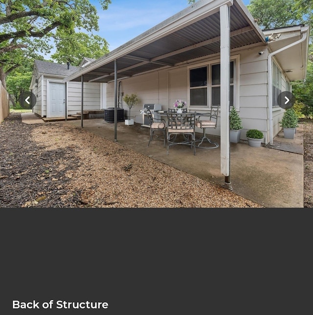 back of property with a patio and central AC unit