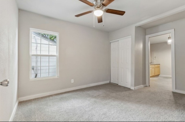 unfurnished bedroom with ceiling fan and light colored carpet