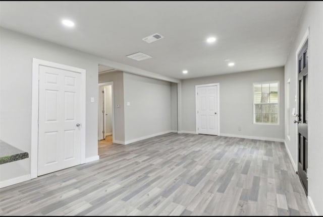 empty room with light hardwood / wood-style flooring