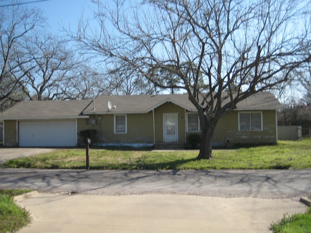 single story home with a garage, concrete driveway, and a front yard