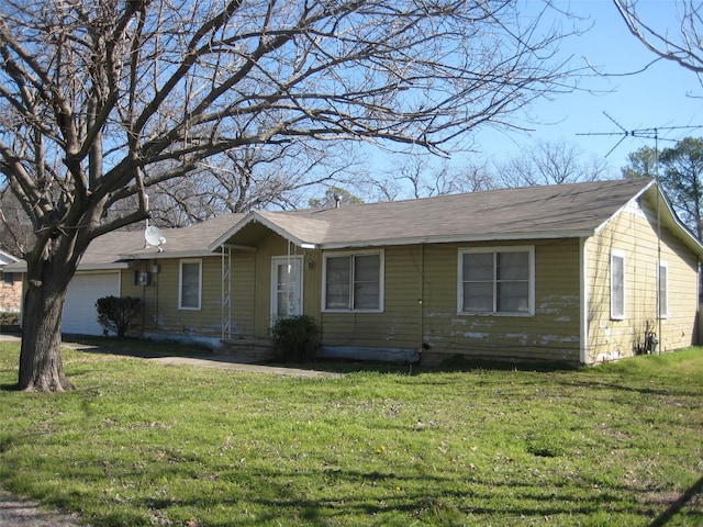 ranch-style house featuring a garage and a front yard