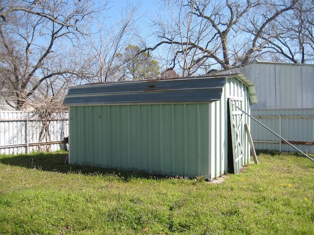 view of outdoor structure with an outbuilding and fence