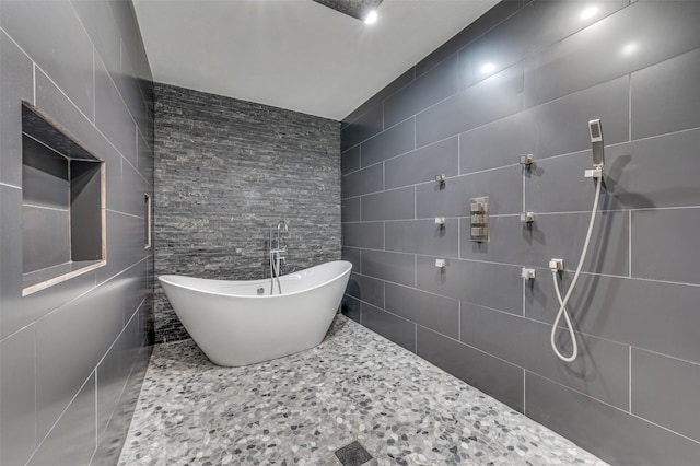 bathroom with plus walk in shower and tile walls