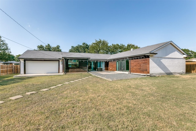 view of front of property featuring a garage and a front lawn