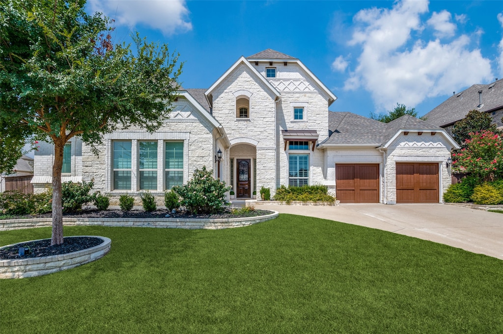 view of front of home with a garage and a front yard