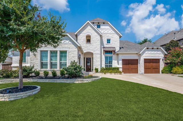 view of front of home with a garage and a front yard