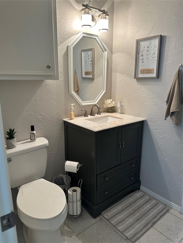 bathroom with toilet, tile patterned floors, and vanity