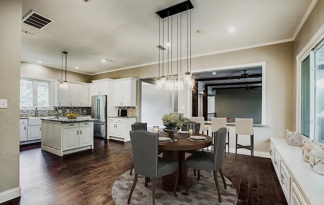 dining area with ceiling fan, ornamental molding, and dark hardwood / wood-style flooring