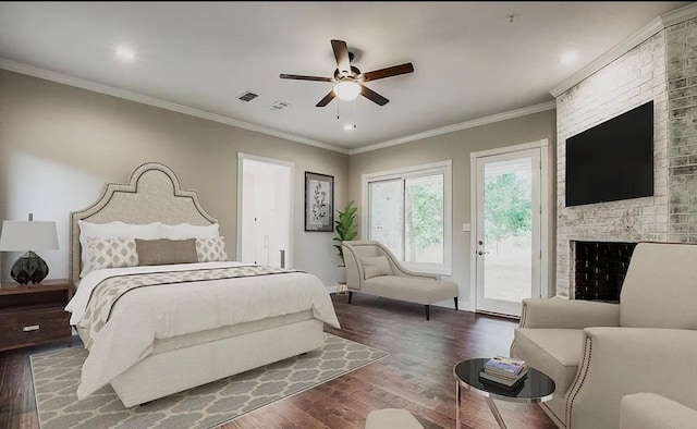 bedroom with ornamental molding, access to exterior, wood-type flooring, ceiling fan, and a brick fireplace