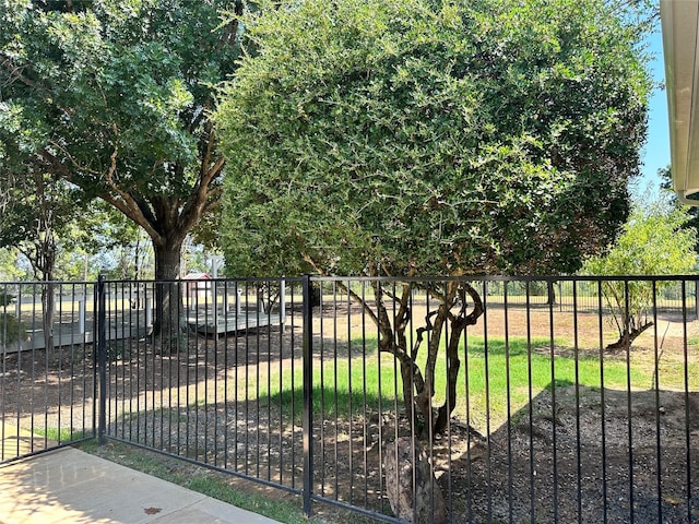 view of gate with a lawn