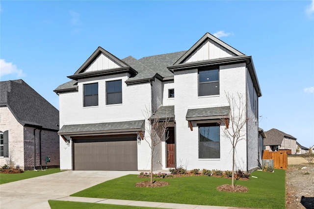 view of front of home featuring a garage and a front lawn