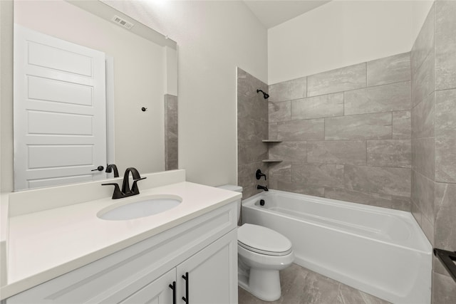 full bathroom featuring vanity, toilet, and tiled shower / bath