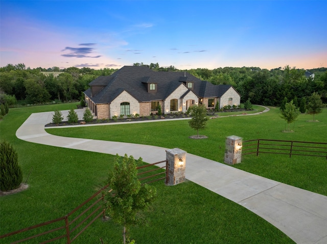 french country style house featuring a lawn