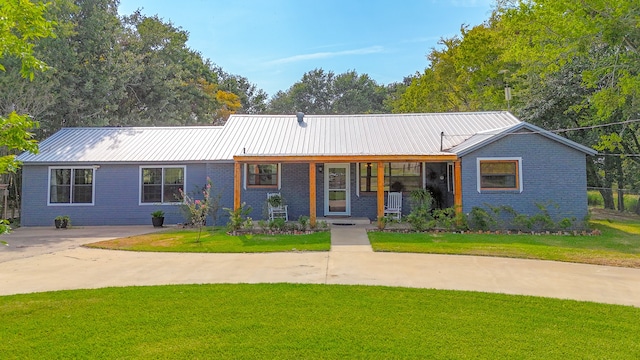 single story home with covered porch and a front yard