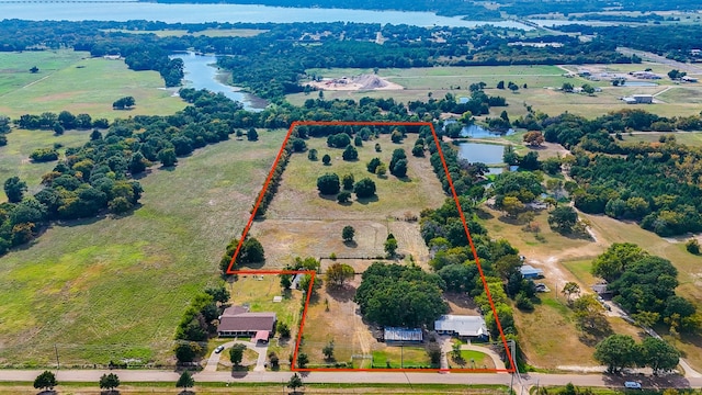 drone / aerial view with a water view and a rural view