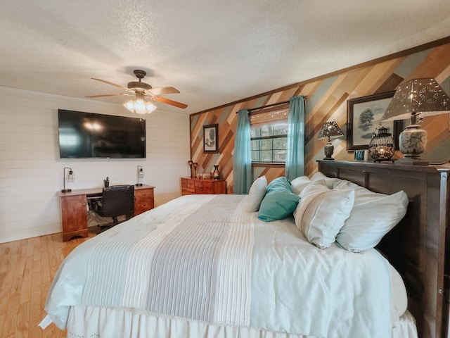 kitchen with appliances with stainless steel finishes, decorative backsplash, light hardwood / wood-style floors, and a textured ceiling