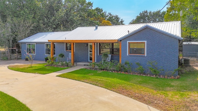 single story home with a front yard and central AC unit