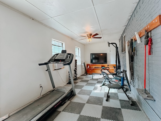 interior space with lofted ceiling, brick wall, ceiling fan, and washer / dryer