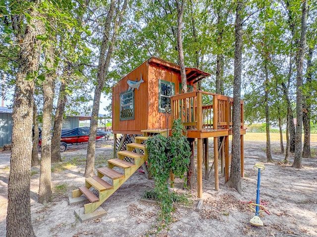 back of house featuring cooling unit, a yard, and a deck