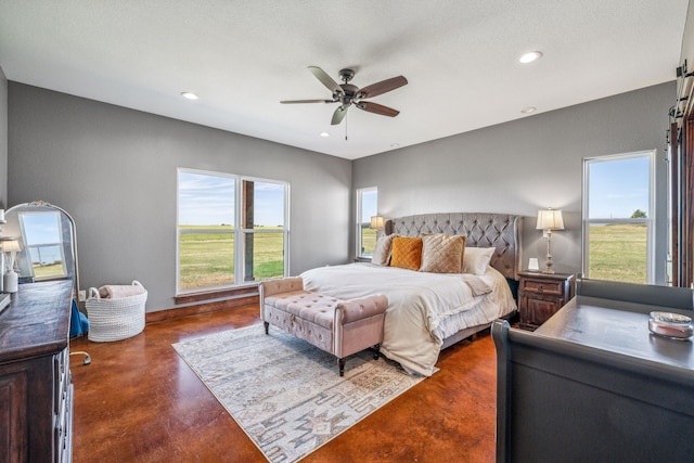 bedroom with ceiling fan and a textured ceiling