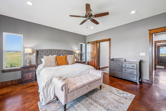 bedroom featuring a barn door and ceiling fan