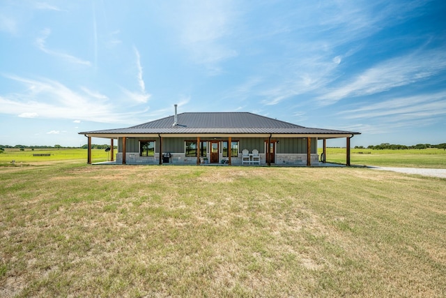 view of community with a lawn and a rural view