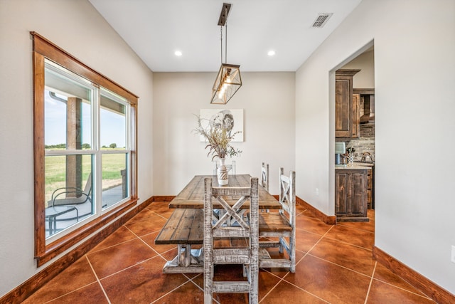 dining room with dark tile patterned floors