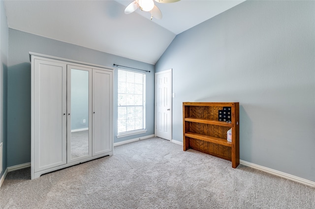 carpeted bedroom with lofted ceiling and ceiling fan