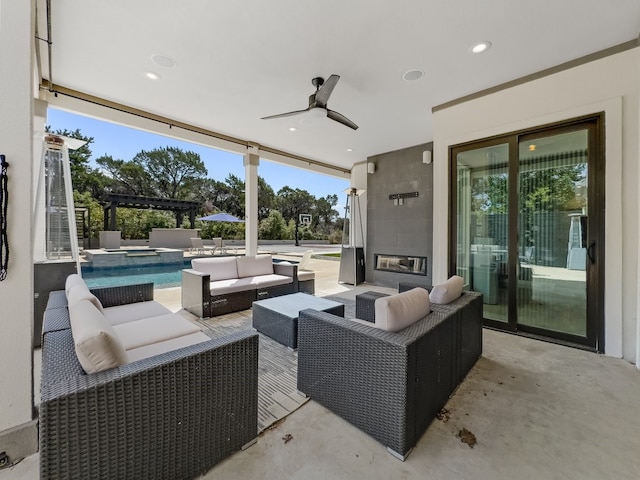 view of patio / terrace featuring an outdoor living space, ceiling fan, and a pergola