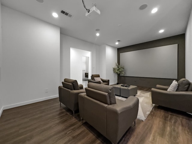 cinema room featuring dark wood-type flooring