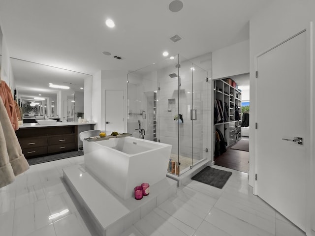 bathroom with shower with separate bathtub, tile patterned flooring, and vanity