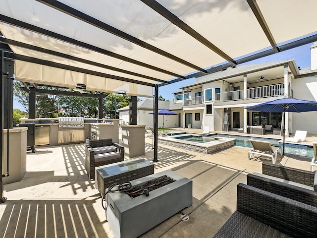 view of patio / terrace with an outdoor kitchen, a pool with hot tub, a balcony, ceiling fan, and grilling area