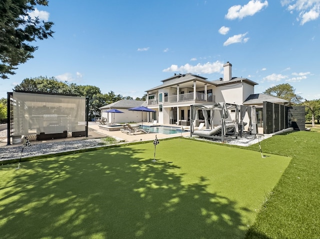 rear view of property featuring a patio and a balcony