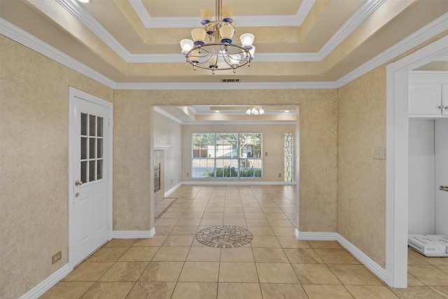 interior space with a chandelier, crown molding, and a tray ceiling