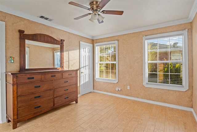 unfurnished bedroom with light hardwood / wood-style flooring, ceiling fan, multiple windows, and crown molding