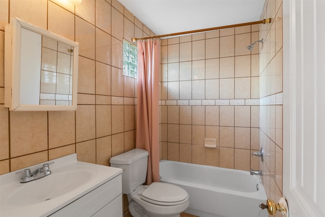 full bathroom with tile walls, vanity, shower / bath combo, and toilet