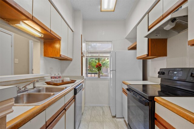 kitchen with dishwasher, white refrigerator, white cabinets, black range with electric stovetop, and sink