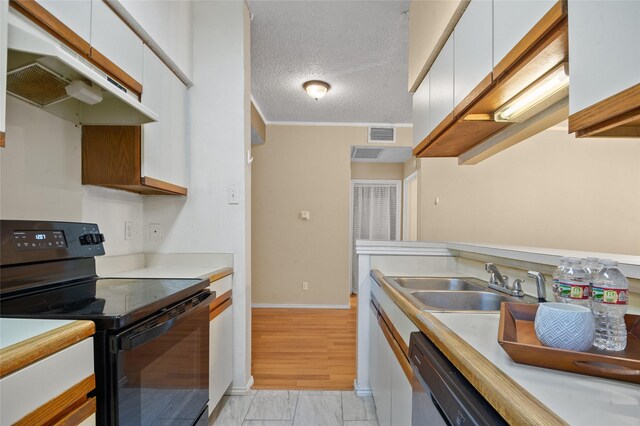 kitchen with a textured ceiling, dishwasher, white cabinetry, sink, and black electric range oven