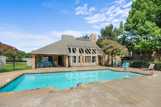 view of pool with a patio area and an outbuilding