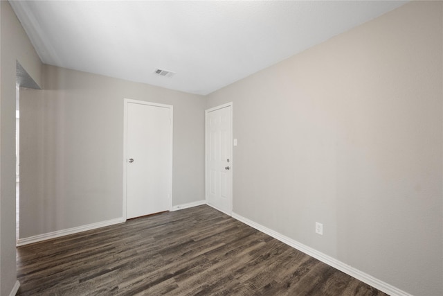 unfurnished room featuring dark hardwood / wood-style floors