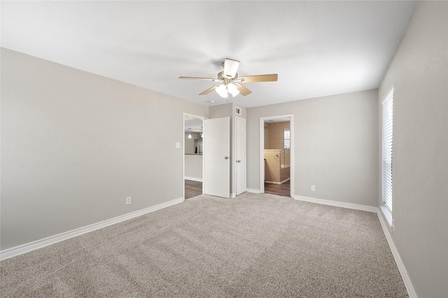 carpeted empty room featuring ceiling fan