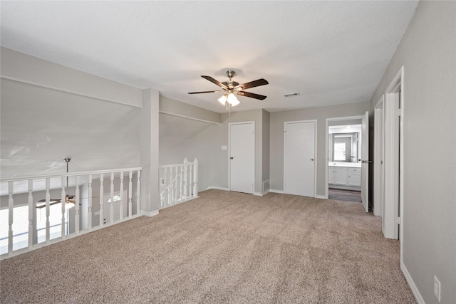 spare room featuring carpet flooring, ceiling fan, and lofted ceiling