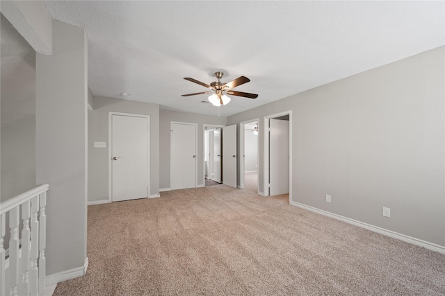 unfurnished bedroom with ceiling fan and light colored carpet