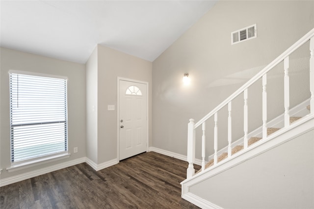 foyer entrance featuring plenty of natural light, dark hardwood / wood-style floors, and lofted ceiling