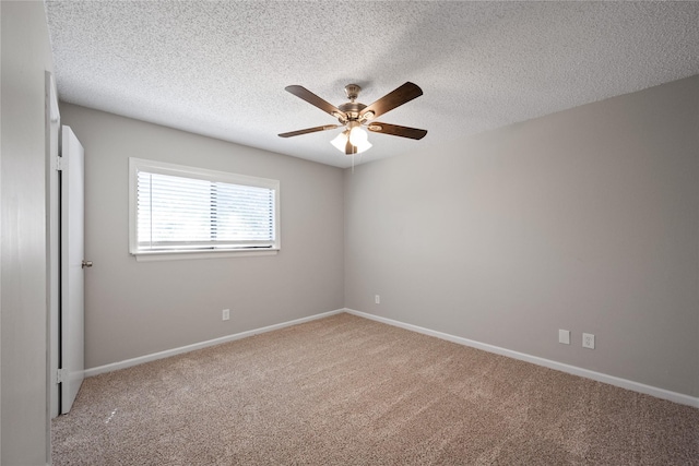 carpeted empty room featuring ceiling fan and a textured ceiling