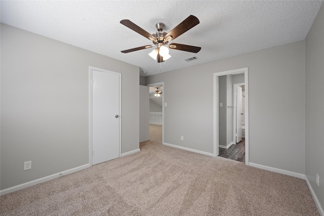 unfurnished bedroom with carpet, ceiling fan, and a textured ceiling